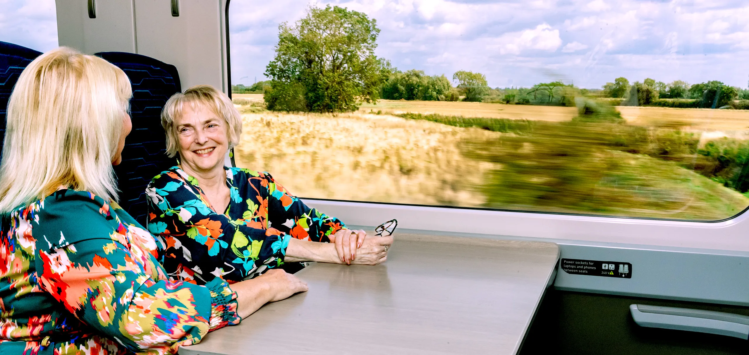 Two women sat at a table onboard a Hull Trains service