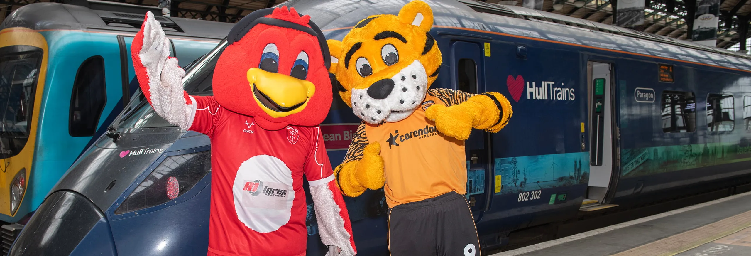 Hull KR and Hull City mascots in front of a Hull Trains service