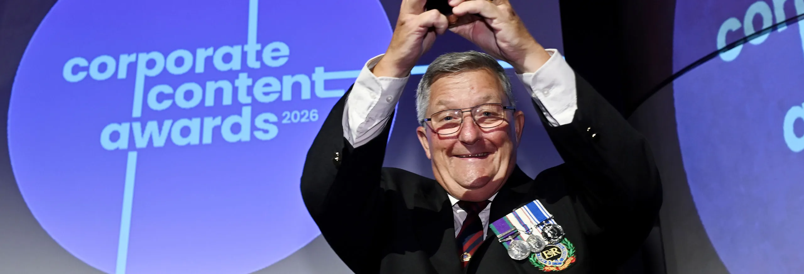 A man holding an award with Hull Trains at the Corporate Content Awards