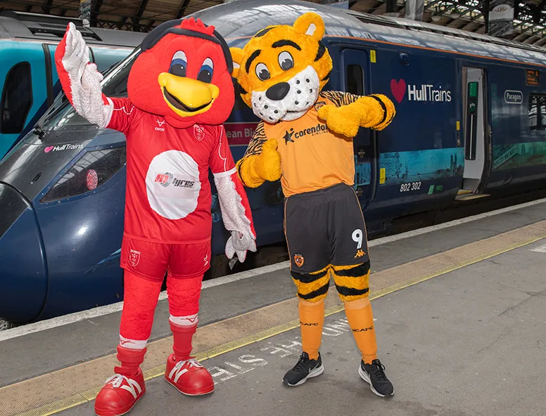 Hull KR and Hull City mascots in front of a Hull Trains service