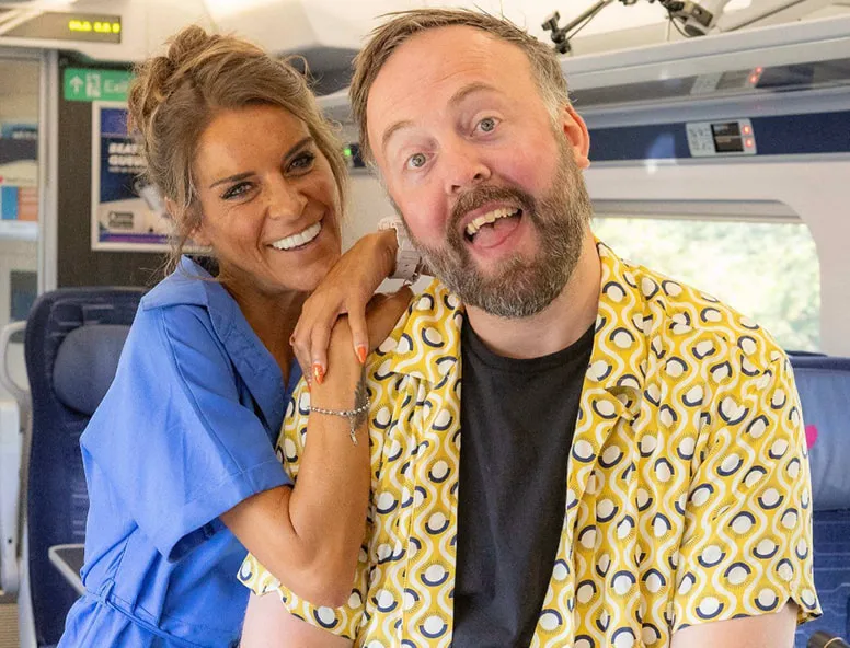 Two people smiling for a photo on the Moving Minds podcast onboard a Hull Trains service