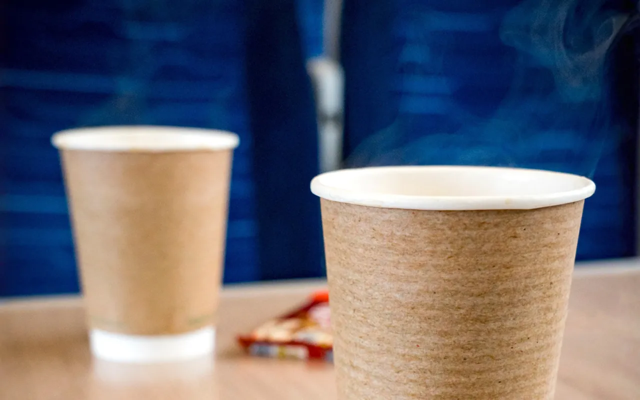 A hot drink steaming on a table onboard a train.