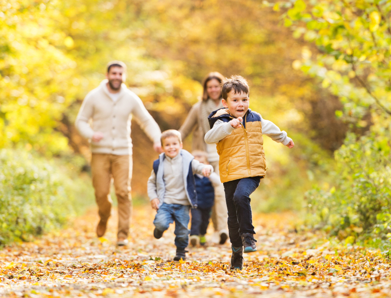Family running outdoors in the Autumn