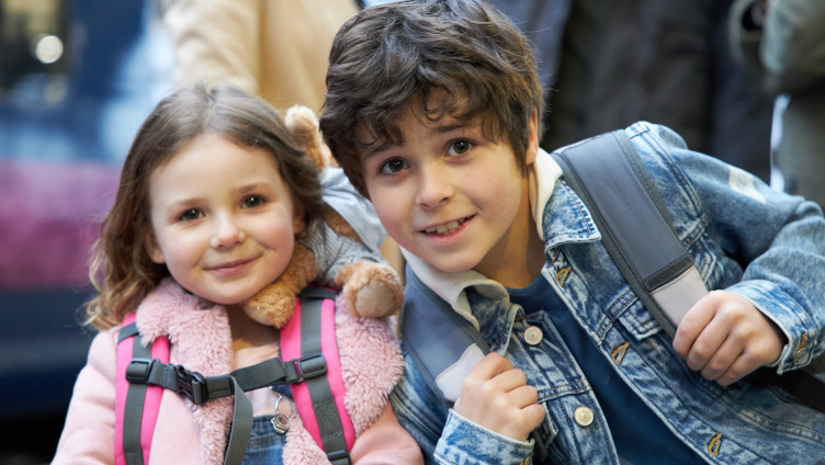 Young boy and girl outside train