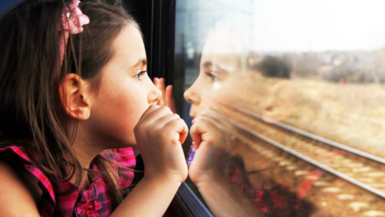 Child on train looking out the window Child on train looking out the window
