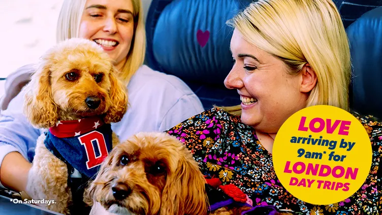Two women and two dogs onboard a Hull Trains service. Text reads Love arriving by 9am for London day trips.